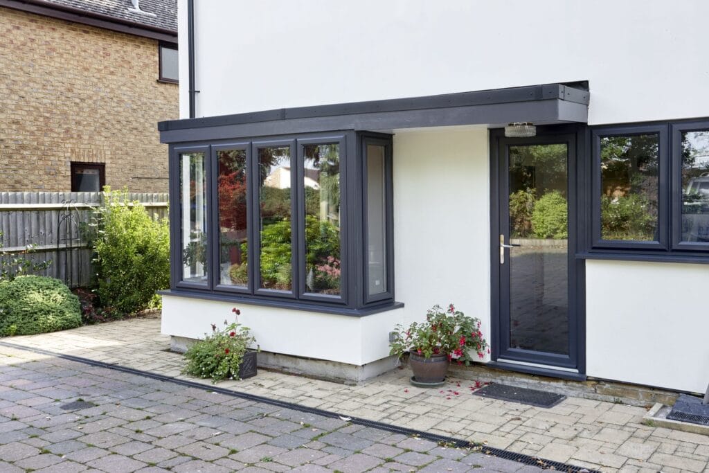 black window and door frames on a white house.