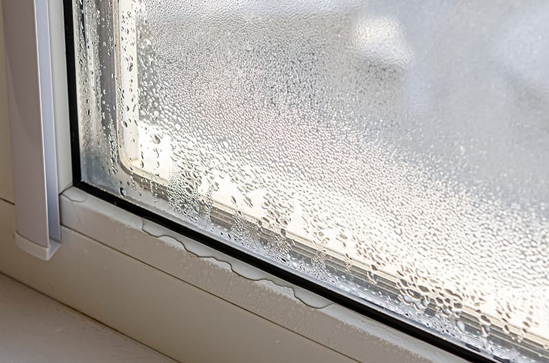 Heavy condensation and water droplets on a failed double-glazed window unit