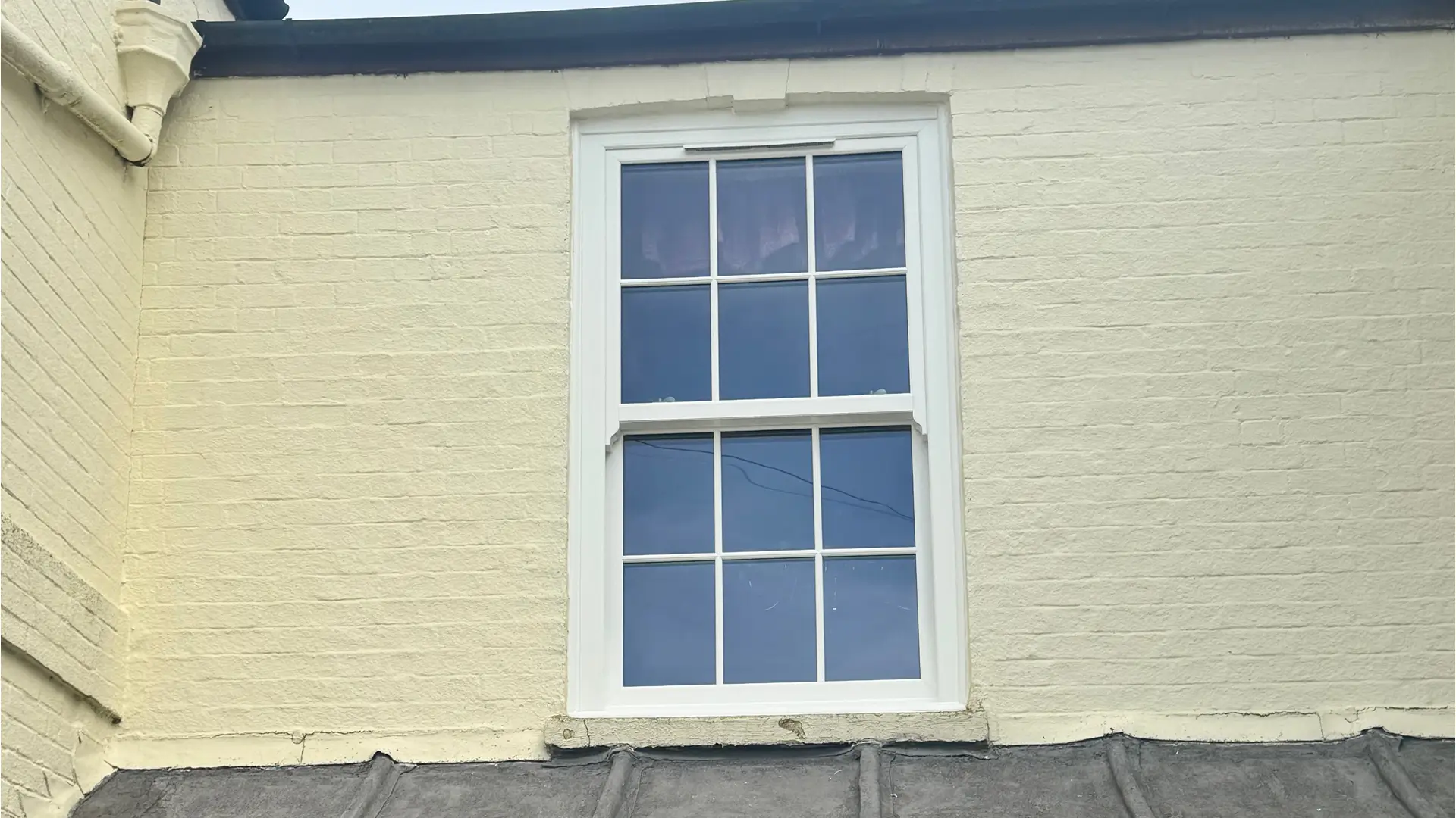 Single sash window on yellow brick wall