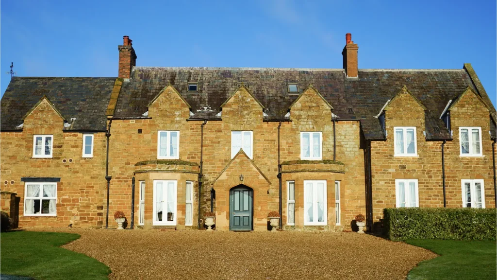 White uPVC casement windows with Georgian bars across entire manor house
